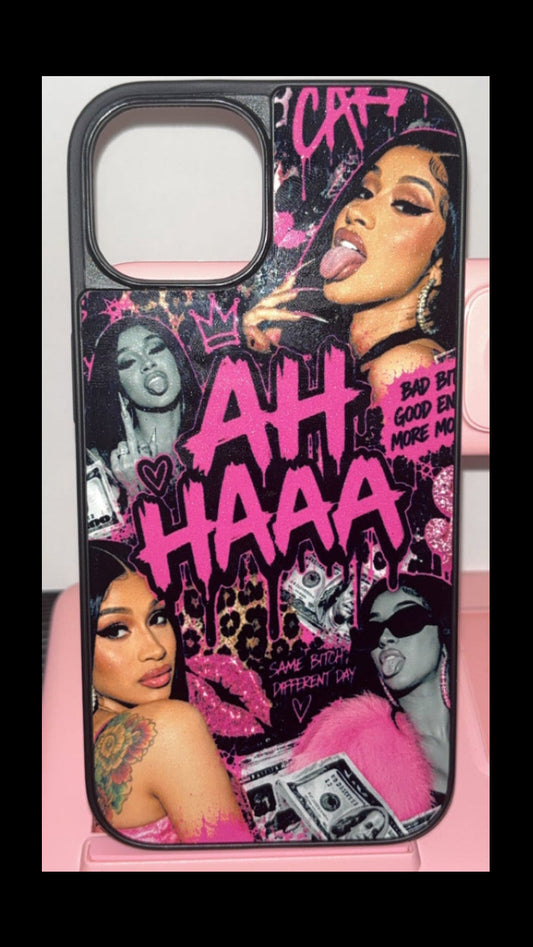A black iPhone case featuring a vibrant pink and black graffiti-style collage print with portraits of Nicki Minaj and the text 'AH HAAA', resting on a pink charging dock.